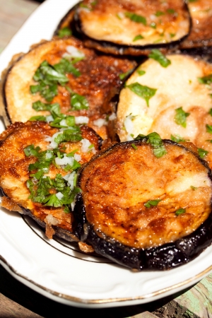 fried eggplant with fresh garlic and parsleyの写真素材
