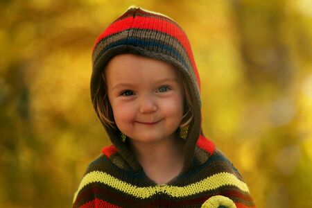 Young blonde girl in autumn parkの素材