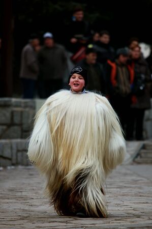 Bulgarian boys hunting evil and demons with traditional costums and danse in carnaval held each yearの素材
