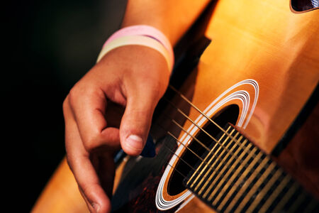 soft fokus hands play on guitar, fokus on stringの写真素材