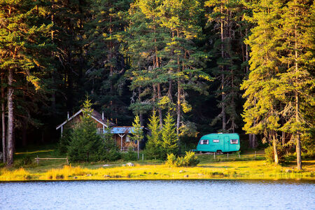 wooden house and caravan near beach on lake, golden sunset colours の写真素材