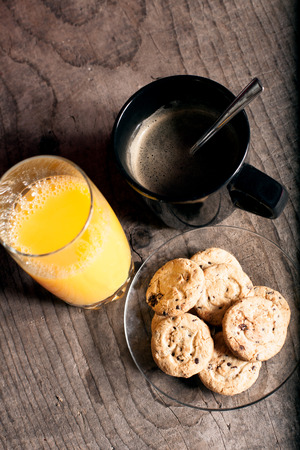 Cofe and orange juice in morning, abstract food background on dirt wooden textureの写真素材