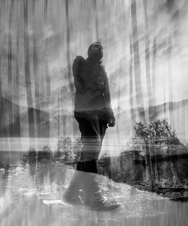 double exposure black and white man portrait walk over the ruins in the forestの写真素材