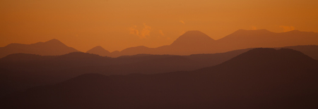 panoramic red sunset over the mountain ridgeの写真素材