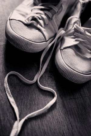 teen daily sneaker shoes conceptual love background, duotone vintage colored backgroundの写真素材