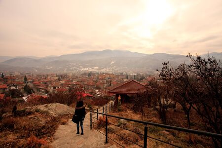 girl tourist walk above the Peristera fortress in Bulgarian mountains, Bulgarian winter tourist background の写真素材