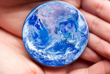 save planet concept with human hand holding small planet Earth- elements of this image furnished by NASAの写真素材