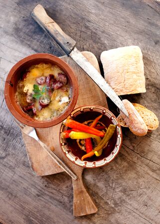 vintage traditional bulgarian food background, vertical orientation, hot pepper and homemade breadの写真素材