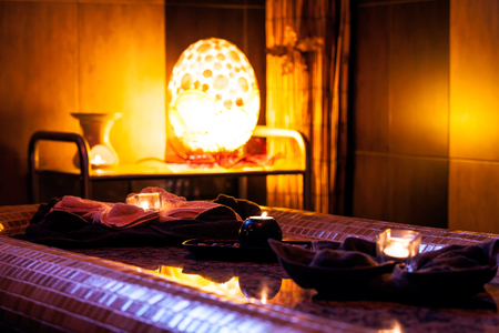 burning candles in spa wellness and massage room in hotelの写真素材