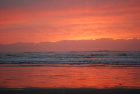 orange sky reflected in waterの写真素材