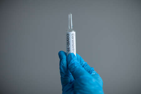 Coronavirus vaccination in a doctors handの写真素材