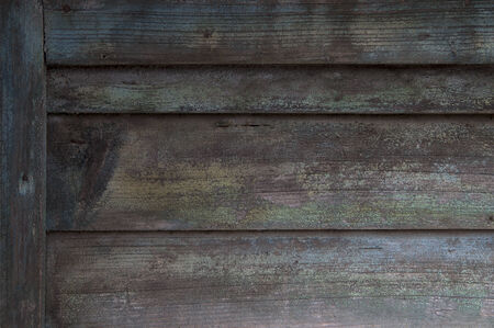detail of dilapidated wooden door with decaying paintの写真素材