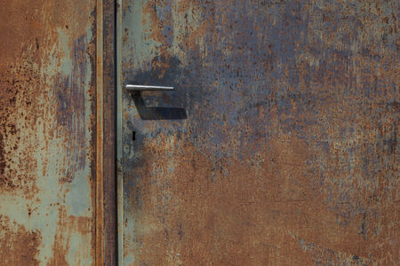 corodded grungy metal door with handleの写真素材
