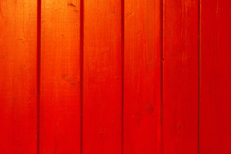 empty red background with blank wooden planks reflecting sunset lightの写真素材