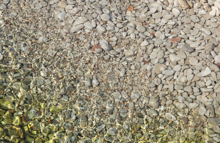 texture of pebbles in shallow sea waterの写真素材
