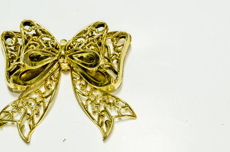 Shiny golden ribbon Christmas decoration on white background の写真素材