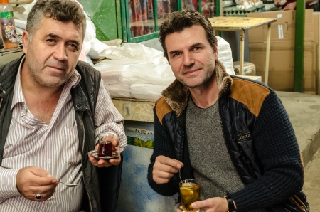 Two turkish men drinking traditional turkish tea in the Old Bazaar in Skopje のeditorial素材