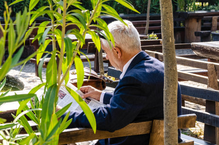 Adult man reading a newspaper の写真素材