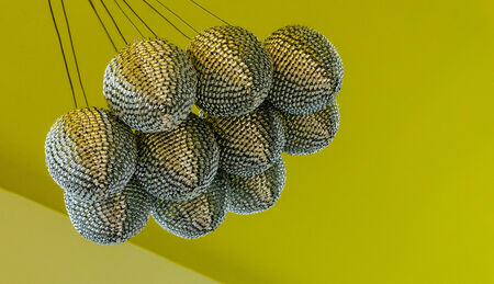  Silver chandelier hanging from the yellow-green ceiling 