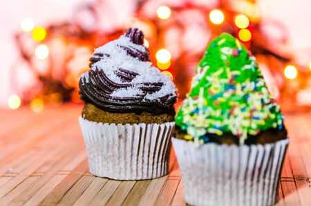 Tree cupcake with green cream and colorful crumbs on top of it 