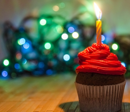 Red cream cupcake with candleの写真素材