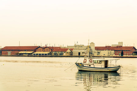 Little boat floating in the waters of the Thessaloniki coast line 
