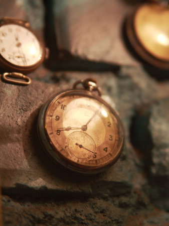 Old watches on the brick wallの写真素材