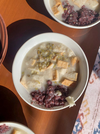 Bowls of food on a table with soup and rice suitable for menu designs, recipe cards, food blogs, or restaurant promotions.の写真素材