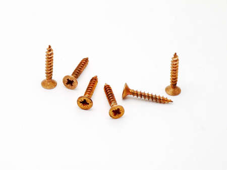 Orange screws over whiteの写真素材