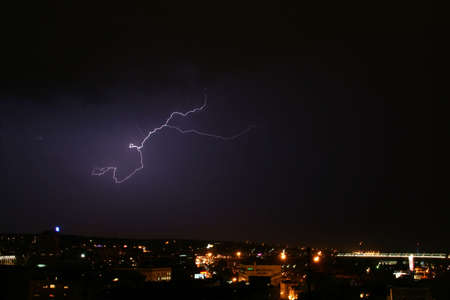 storm and a bolt of lightning over city