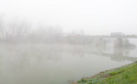 Traffic jam on the bridge over the Sava River in Bosanski Brod on a cold and foggy autumn morning.の写真素材