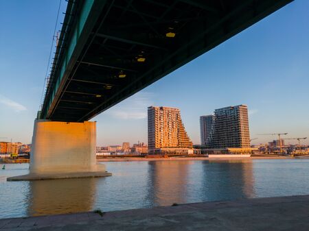 View of the city and skyscrapers of Belgrade waterfront under the Old Sava bridge. Cityscape of Belgrade at twilight.の写真素材