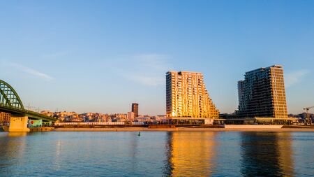 View of the city and skyscrapers of Belgrade waterfront under the Old Sava bridge. Cityscape of Belgrade at twilight.の写真素材