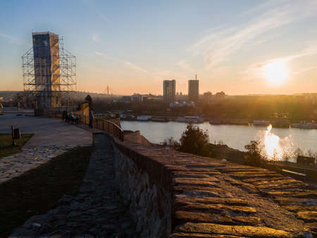 The Victor - Pobednik under reconstruction on Kalemegdan fortress and cityscape of Belgrade, Serbia, at sunset.のeditorial素材