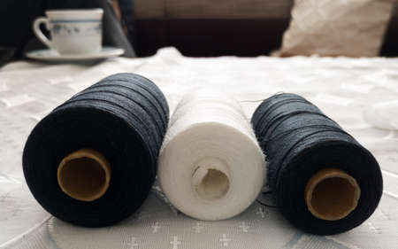 Sewing machine threads on the table in the living room.