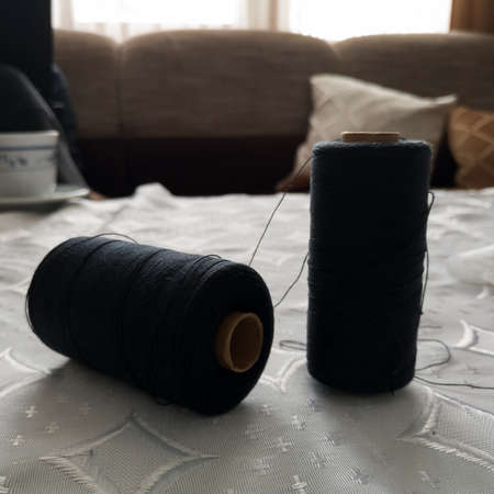Sewing machine threads on the table in the living room.