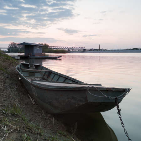 Riverbank of Sava river in Bosanski Brod, Bosnia and Herzegovina with fishing hut, moored boats...