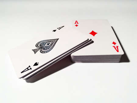 Cut deck of playing cards with spades and diamonds, isolated on a white background