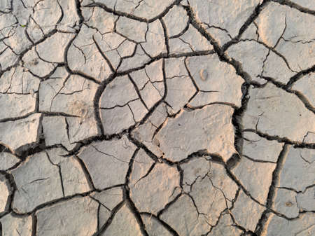Arid and barren land caused with hot weather and drought, erosion and crack ground, abstract mosaic...