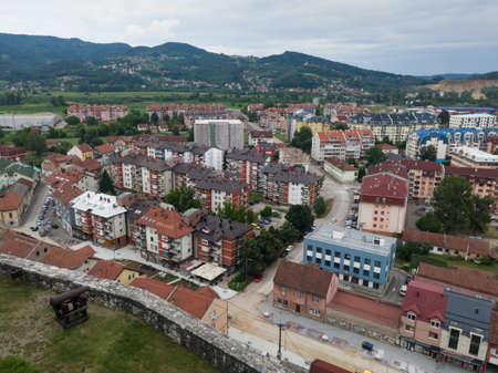 View of the town of Doboj and the hilly countryside from the Gradina fortress on the hill above the town during a cloudy summer dayのeditorial素材