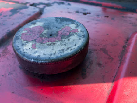 Old dirty red fuel tank with round metal lid , agricultural machineryの写真素材