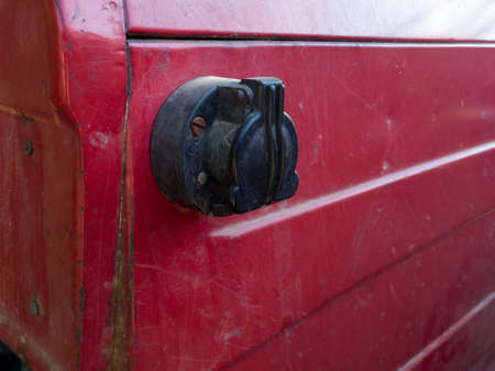 Close up of trailer socket on fender of old red tractor, agricultural machinery partの写真素材