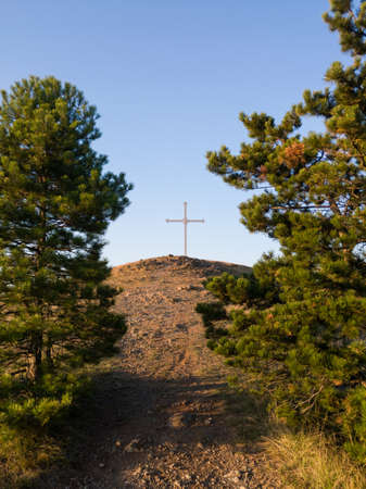 Large cross at the top of Gostilj on the mountain Ozren at afternoonの写真素材
