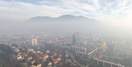 Aerial view of Sarajevo in the fog and the TrebeviÄ mountainのeditorial素材