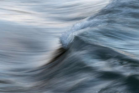 Silky texture of water wave in long exposure and motion blur - abstract landscape close up