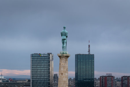 Victor (pobednik) monument close up from behind during overcast day, and New Belgrade in backgroundのeditorial素材