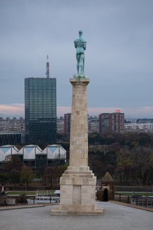 Victor (pobednik) monument close up from behind during overcast day, and New Belgrade in backgroundのeditorial素材