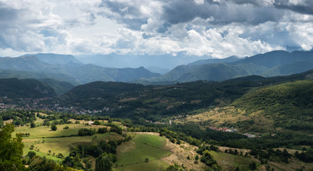 Settlement in valley surrounded with mountains, countryside near Prozor in Bosnia and Herzegovina, mountain landscapeの写真素材