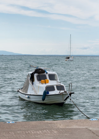 Moored motorboat in Adriatic sea during overcast dayの写真素材