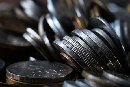 Pile of various coins close up, edges are plain or reeded, uncirculated coins